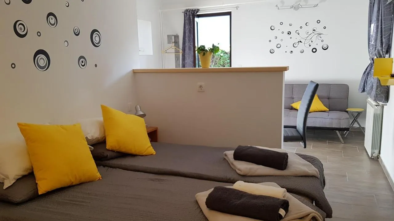 Two single beds with yellow cushions