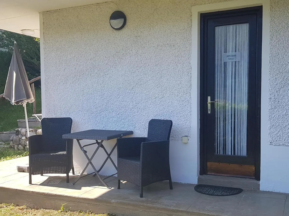 Studio entrance and terrace with a table and chairs